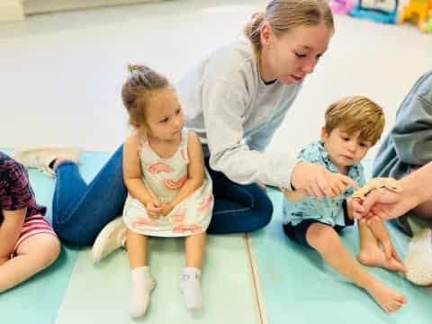 a person and two children sitting on a bench