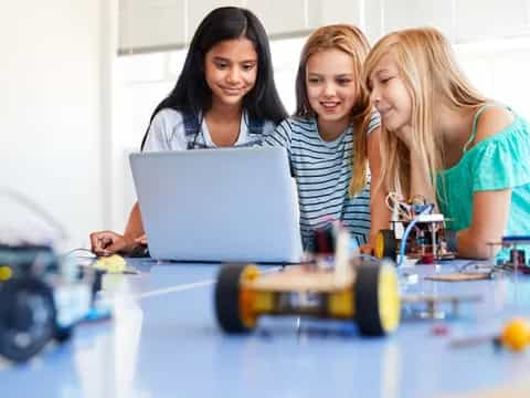 a few young women working on a laptop
