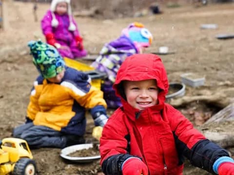 a group of children playing in the dirt