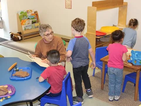 a person and children in a classroom