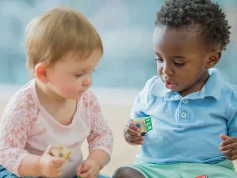 a couple of young children playing with a toy