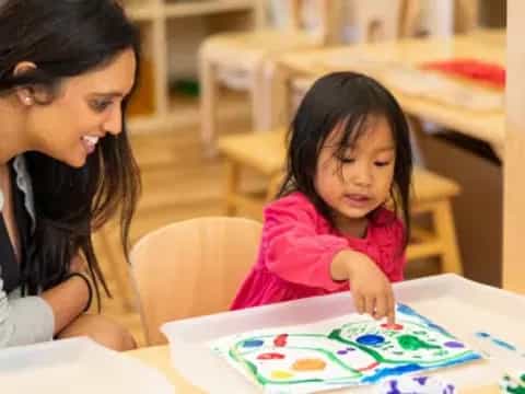 a person and a child sitting at a table