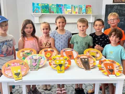 a group of children holding cupcakes