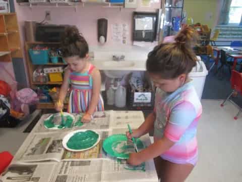 a couple of young girls playing with toys in a room
