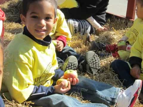 a group of children sitting on the ground
