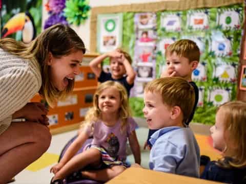 a person and several children in a classroom