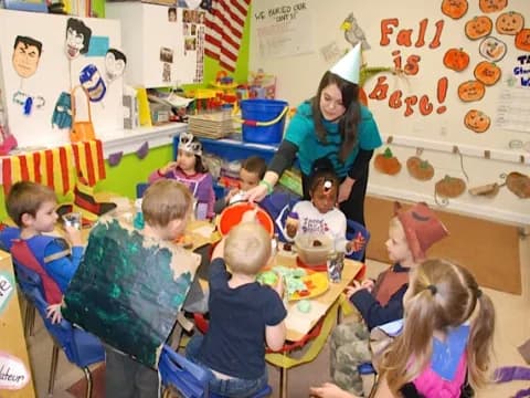 a person and several children in a classroom