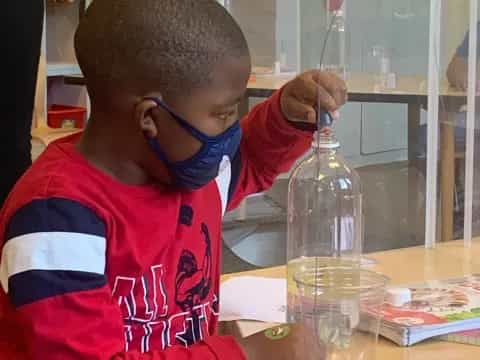 a young boy wearing a stethoscope and a red shirt