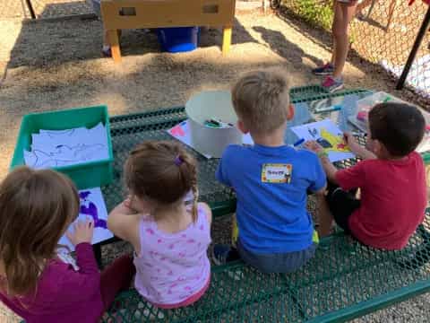 a group of children sitting on the ground