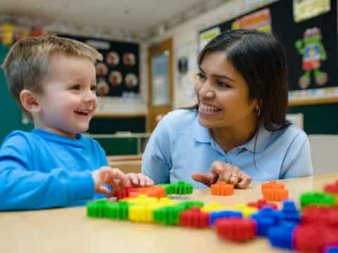 a person and a child playing with toys