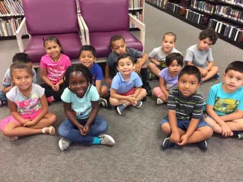 a group of children sitting on the floor