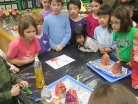 a group of children sitting at a table