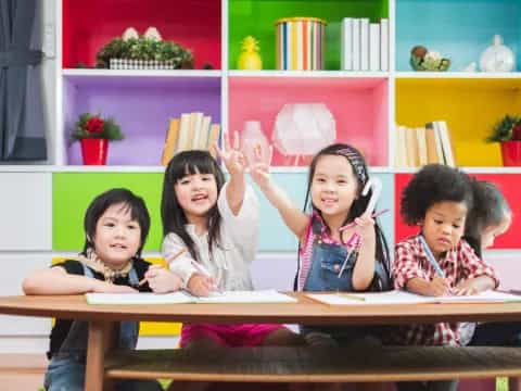 a group of children sitting at a table