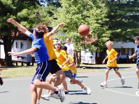a group of people playing basketball