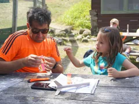 a person and a girl painting outside